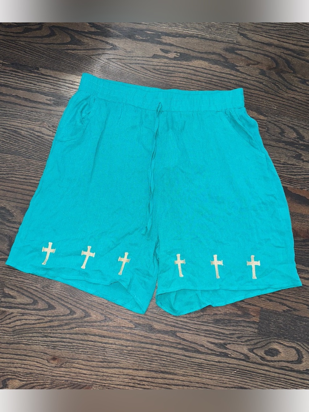 Grace & Emma vibrant turquoise drawstring shorts w/ embroidered row of crosses